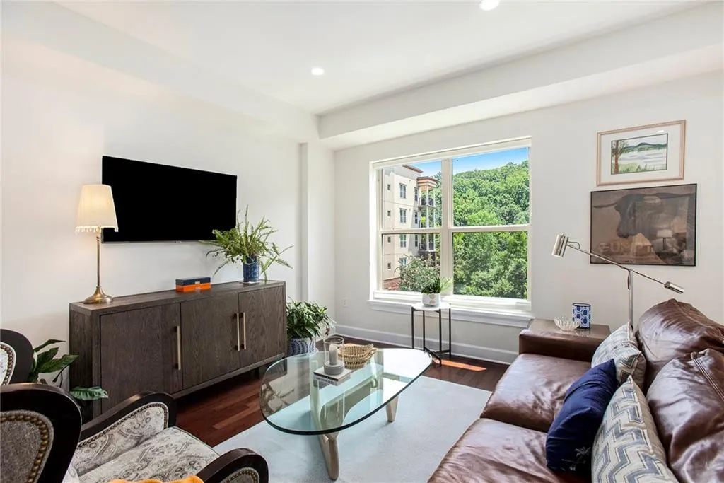Living room with dark wood-type flooring and a wealth of natural light