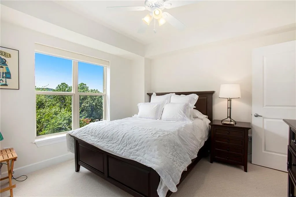 Bedroom featuring light colored carpet and ceiling fan
