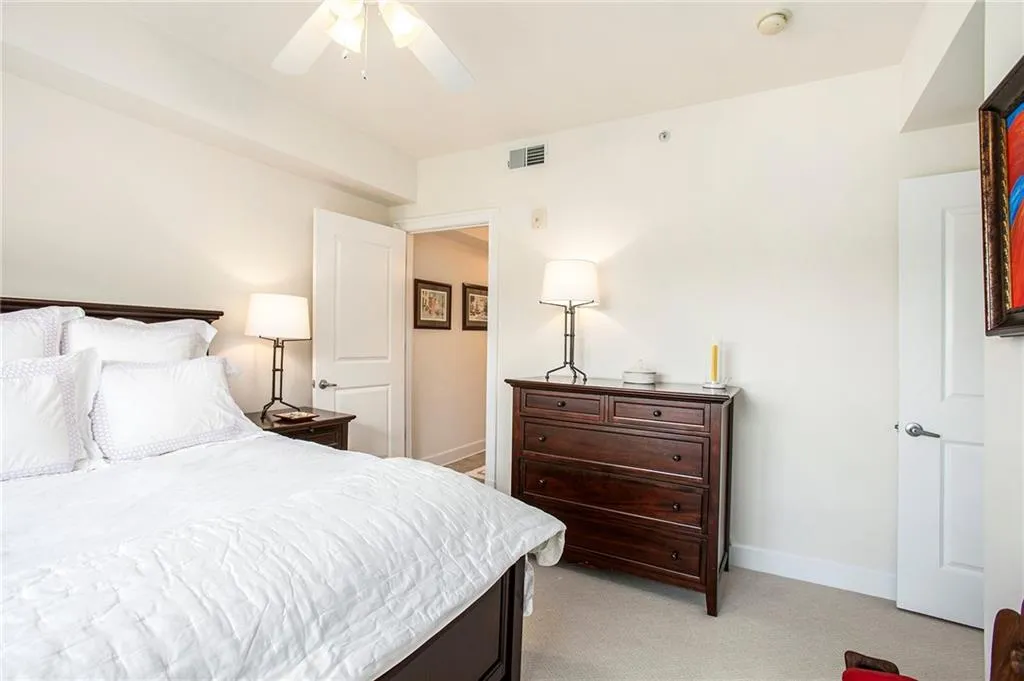 Bedroom featuring ceiling fan and light colored carpet
