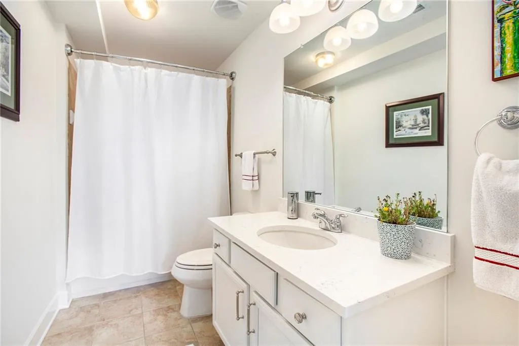 Bathroom featuring vanity, tile patterned floors, and toilet