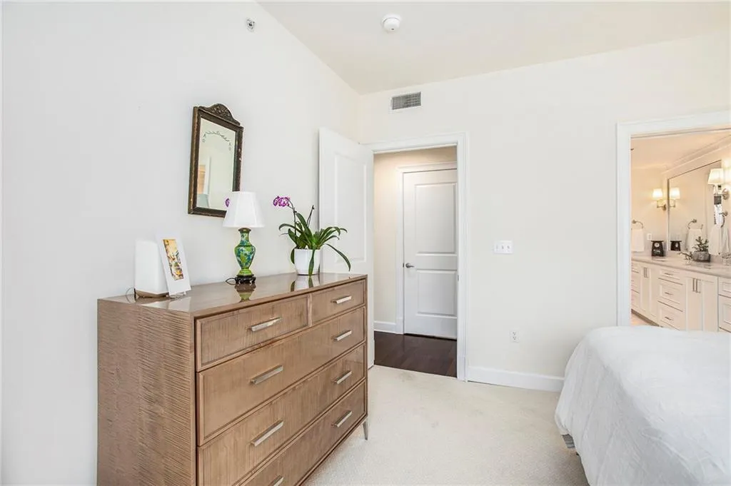 Carpeted bedroom with ensuite bathroom