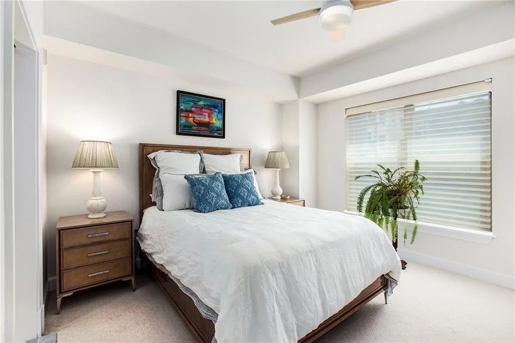 Bedroom featuring light carpet and ceiling fan