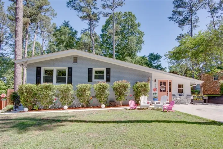Single-story residence featuring light gray brick and white siding