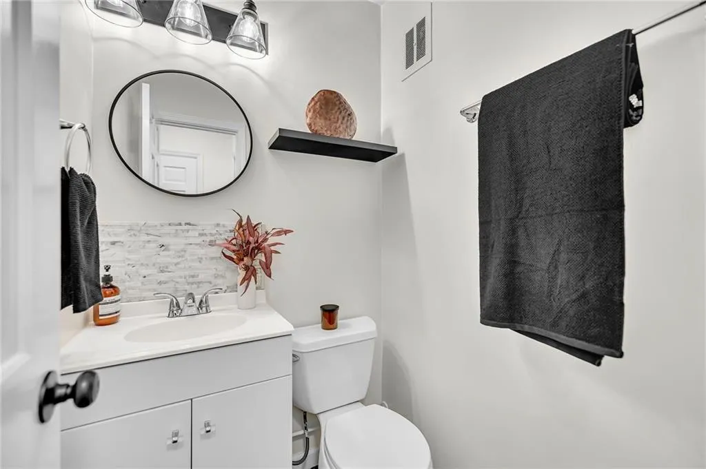 Bathroom with tasteful backsplash and vanity