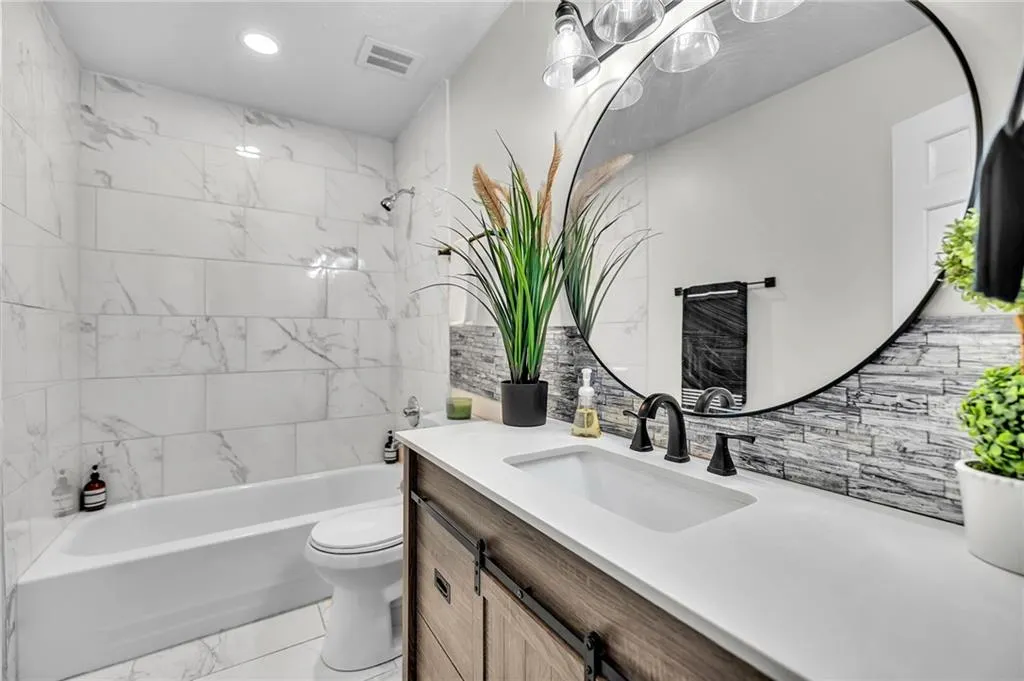 Full bath with bathtub / shower combination, vanity, tasteful backsplash, and recessed lighting
