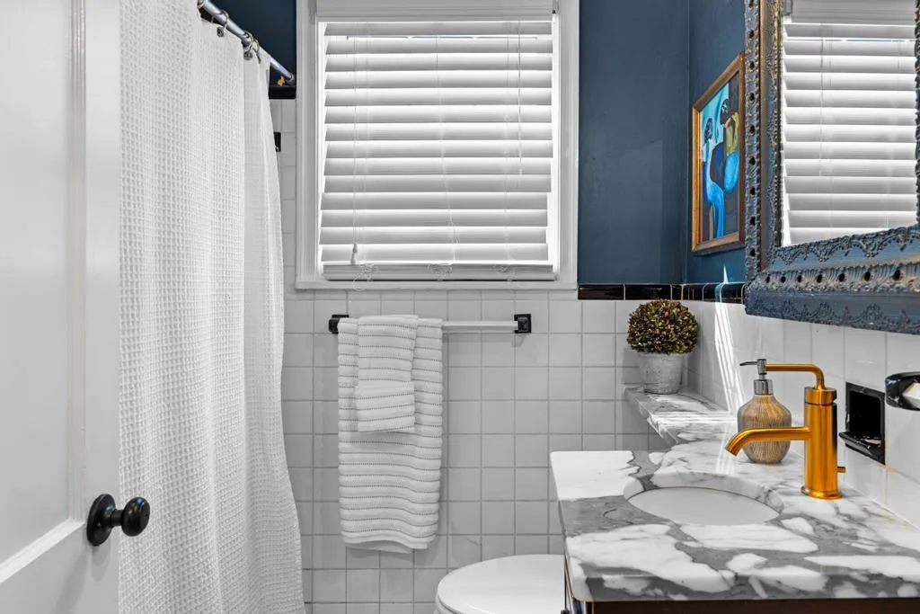 Main level hall bath with marble counter tops