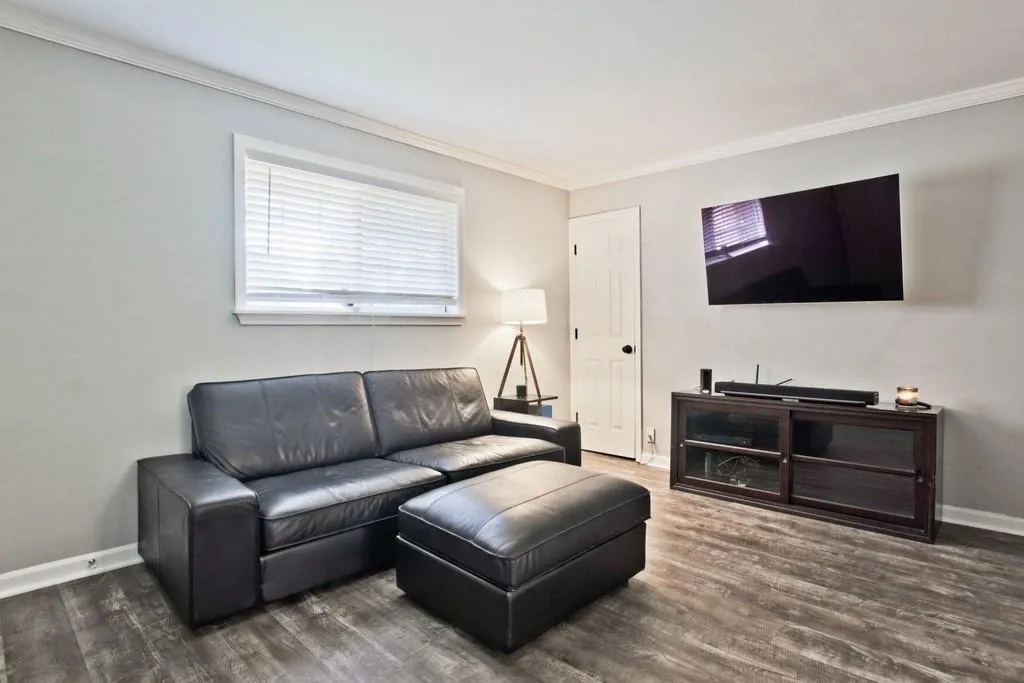 Living room featuring ornamental molding and dark wood finished floors
