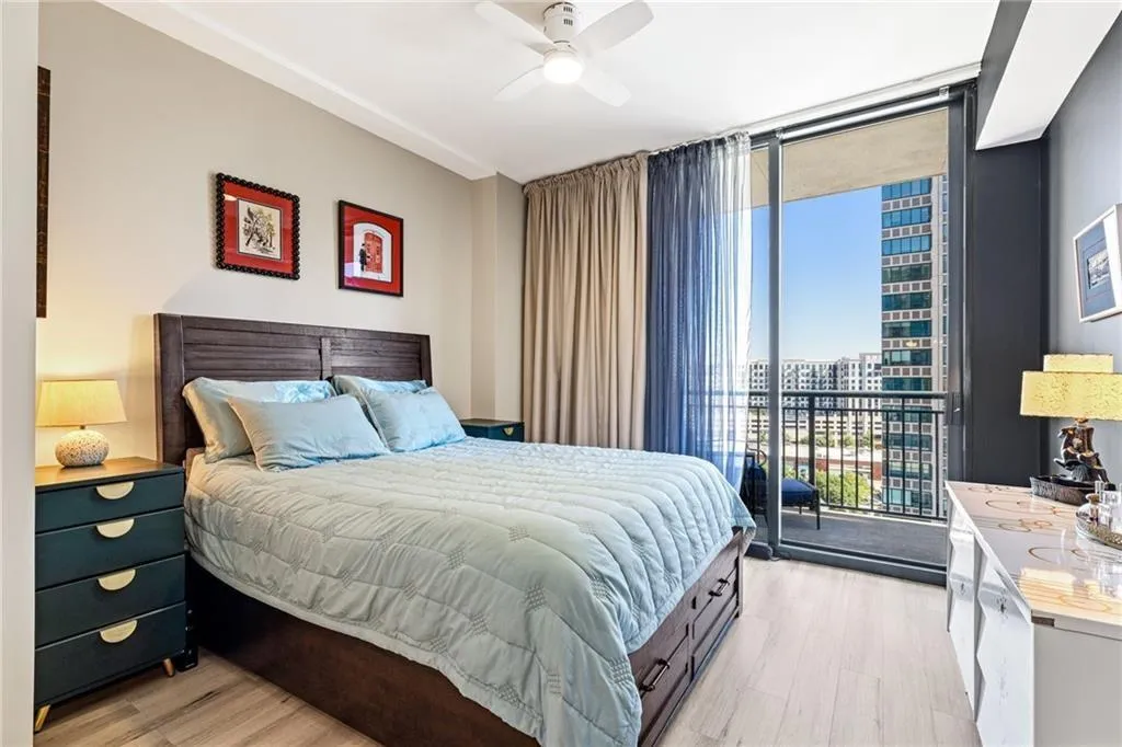 Sliding glass doors provide access to a private balcony