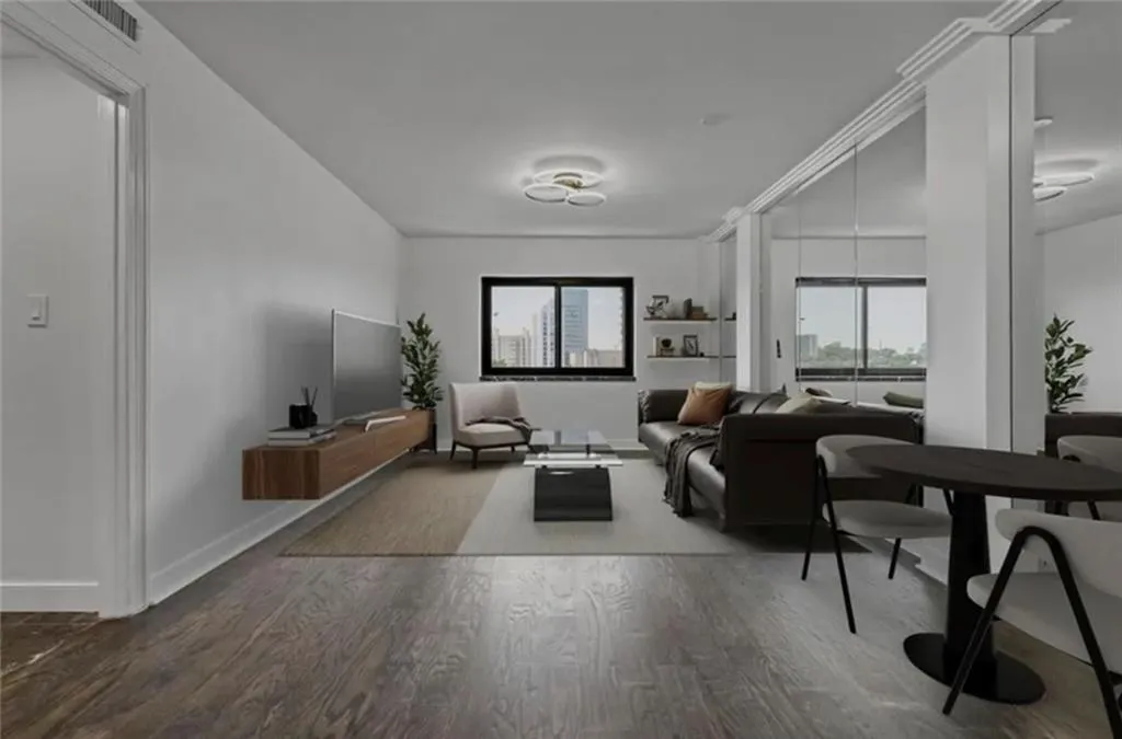 Living area with wood finished floors and healthy amount of natural light