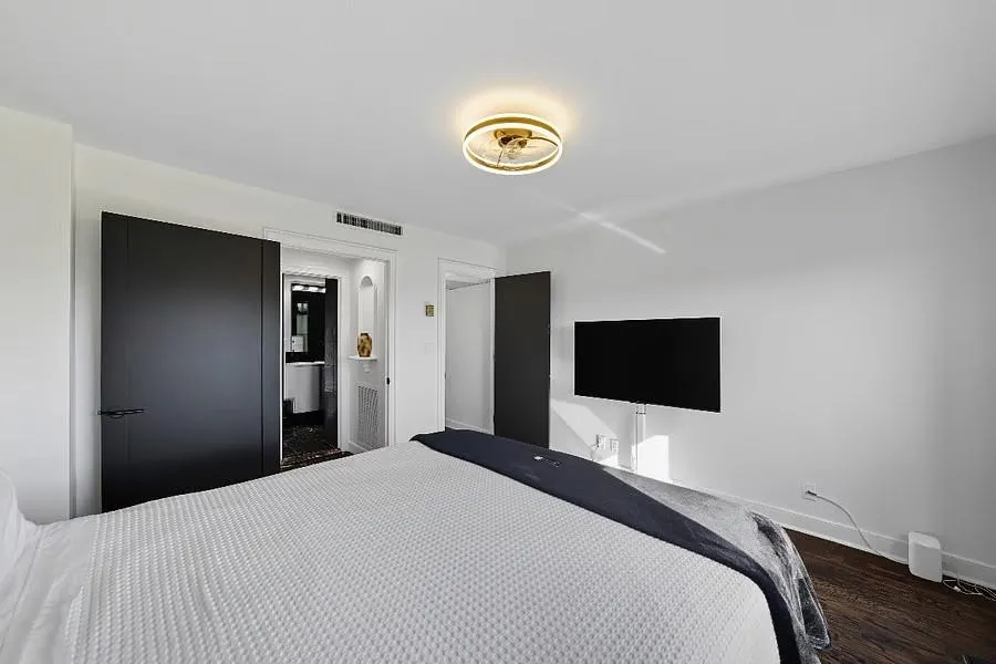 Bedroom featuring wood finished floors and ensuite bathroom