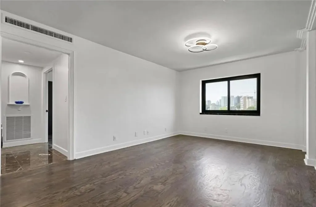 Empty room with dark wood finished floors