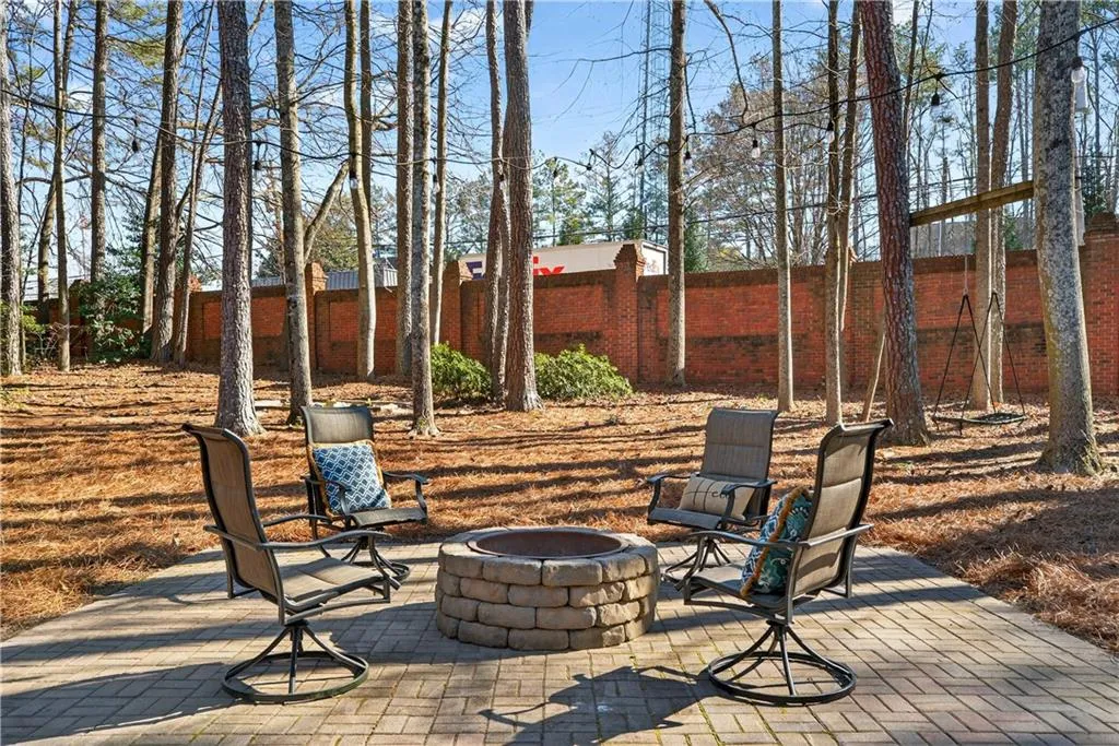 Fenced backyard featuring a patio and a fire pit