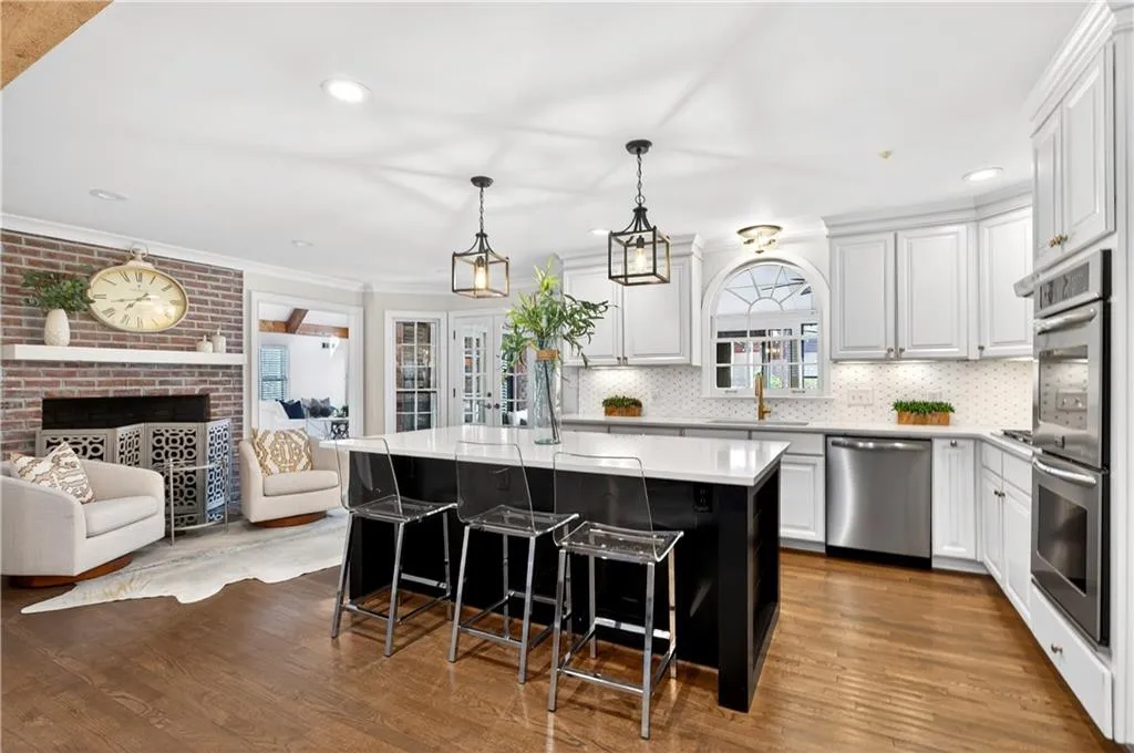 Open kitchen adjacent to fireplace and sitting area.