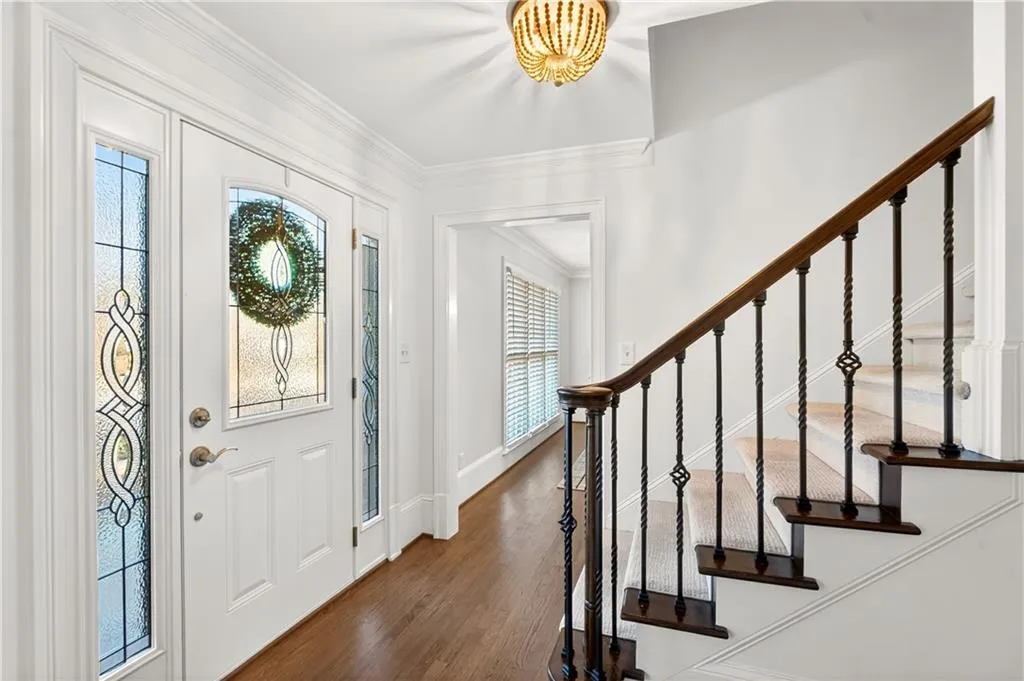 Foyer entrance featuring dark wood floors.