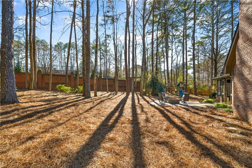 Fenced backyard with a playground and a patio
