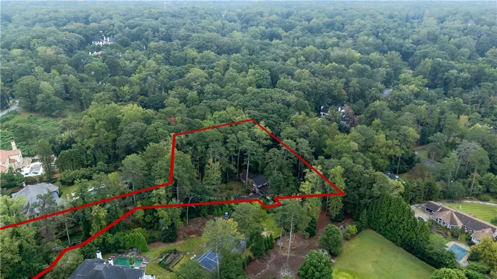 Aerial view of property and surrounding area with property parcel outlined