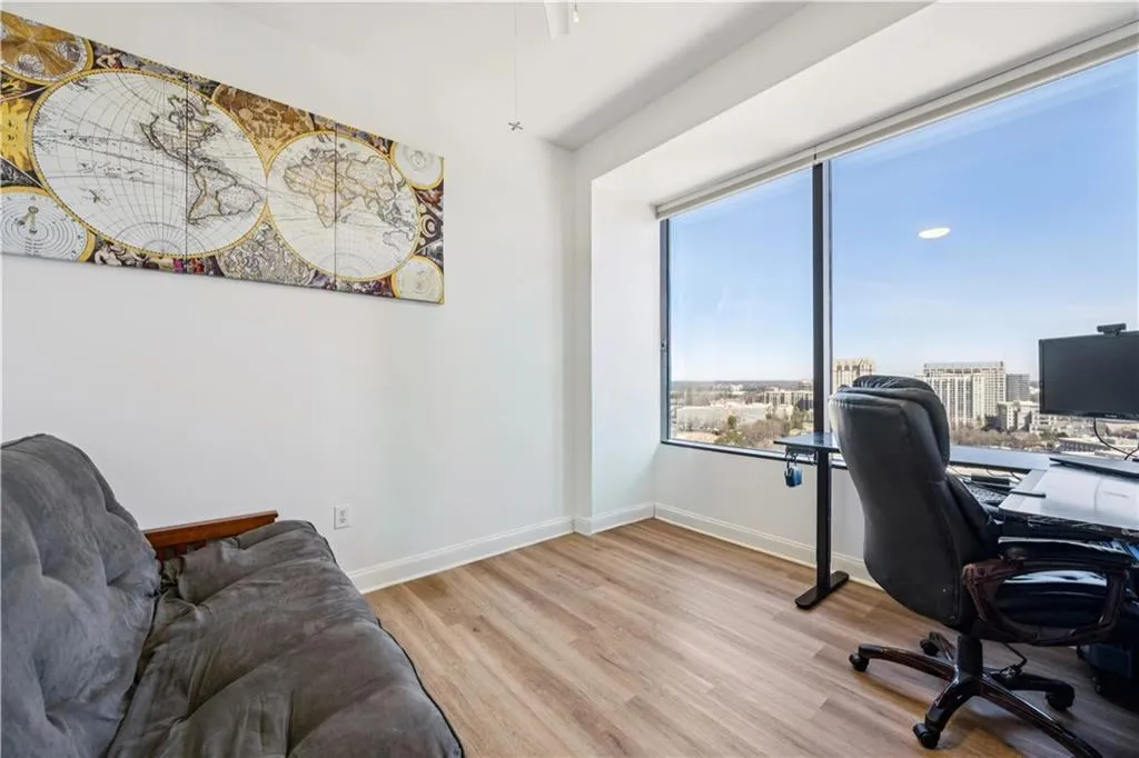 Office with light wood-style floors and baseboards