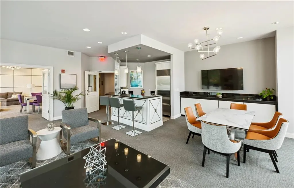 Dining space featuring a chandelier, dark colored carpet, and recessed lighting