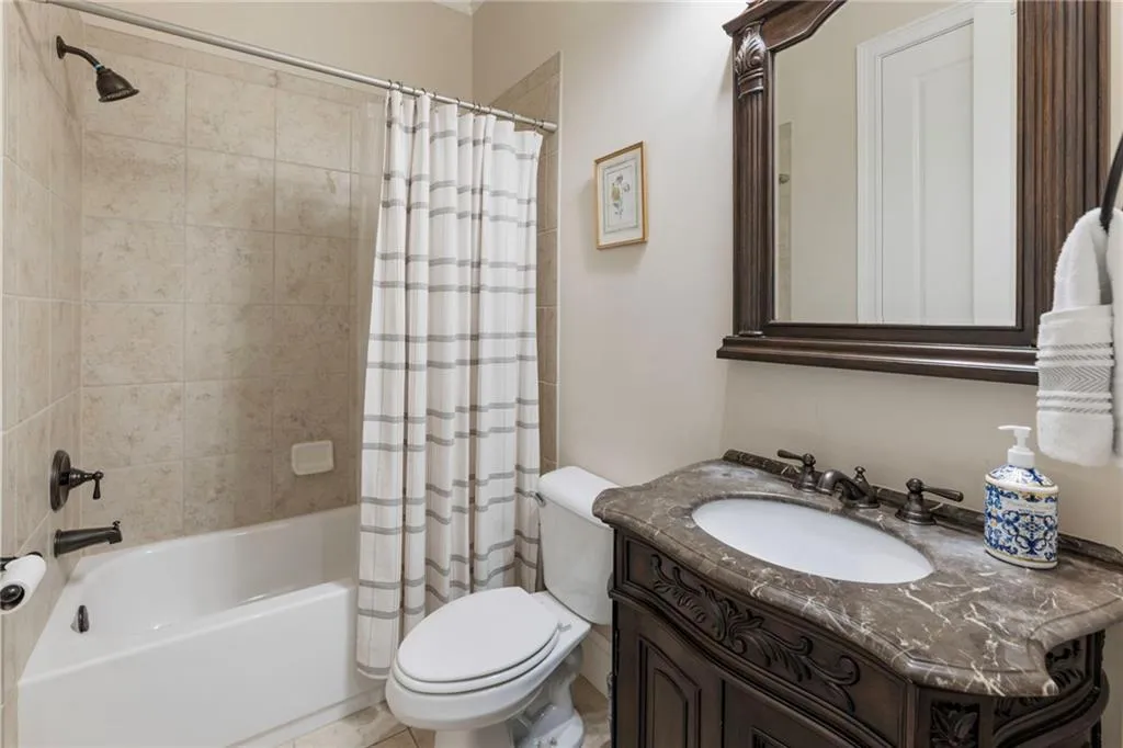 Full bathroom featuring shower / bath combo with shower curtain and vanity