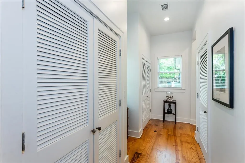 Hallway leading to the back bedrooms.   The closet on the left houses the tankless water heater.   The closet at then end of the hallway is more storage space.