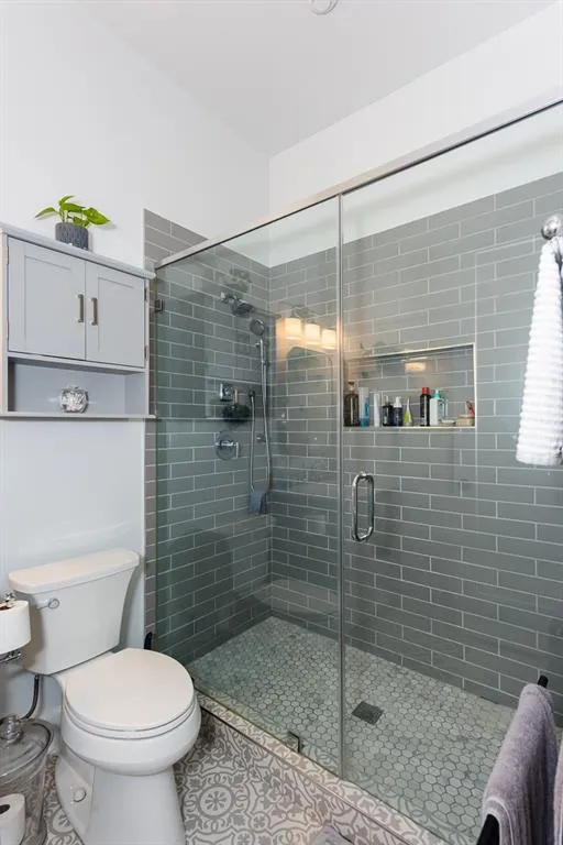 The second full bathroom has a large walk in shower with glass doors.   Notice the wall niche for all of your lotions.