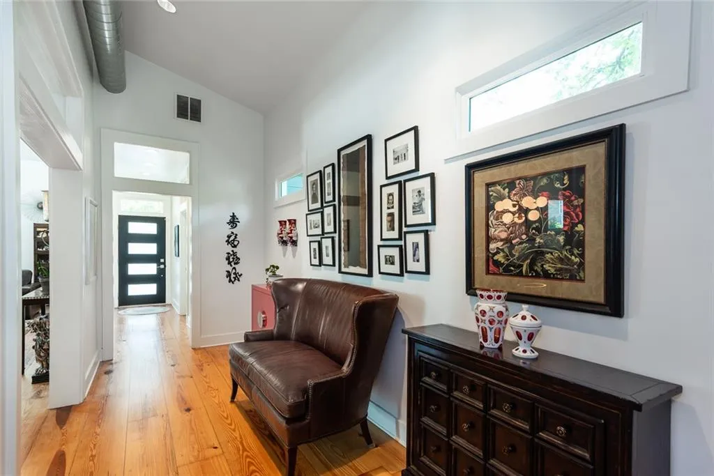 This view is stepping outside of the kitchen looking to the front door.   Look at all of the natural light!