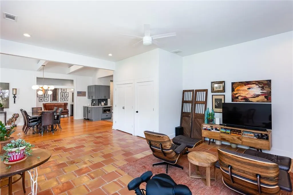 The flex room was an addition to the original footprint of this home.  The handmade Saltillo tile blends beautifully with with the 12 inch wide pine plank flooring in the rest of the home.
