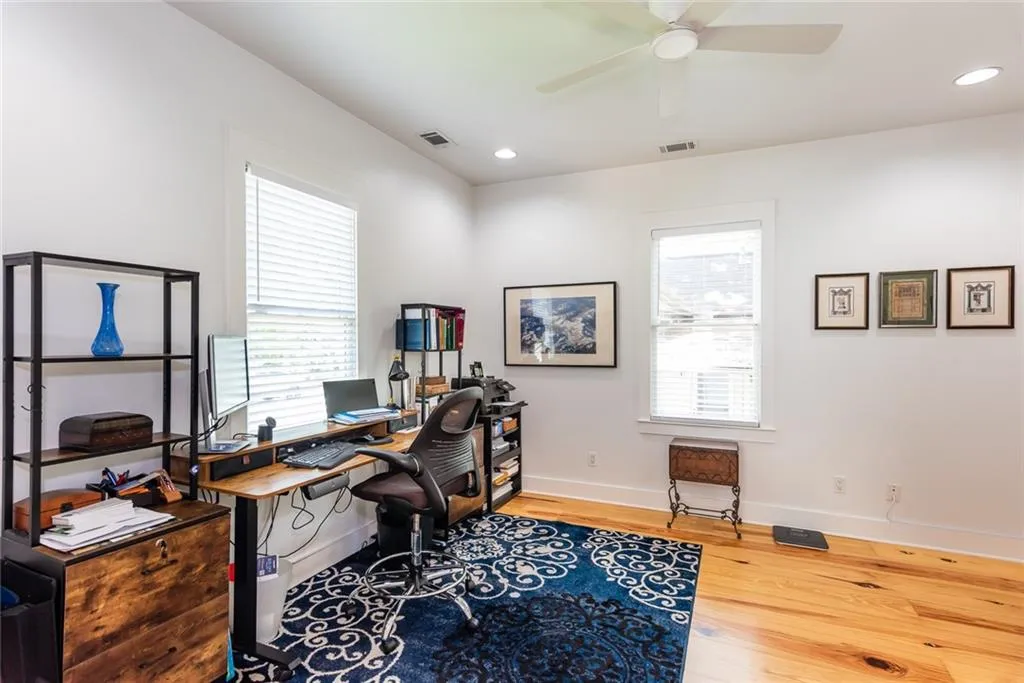 The first bedroom on the front of the house is currently being used as a home office.   This room has plenty of natural light, a ceiling fan, and original 12 inch wide pine flooring.
