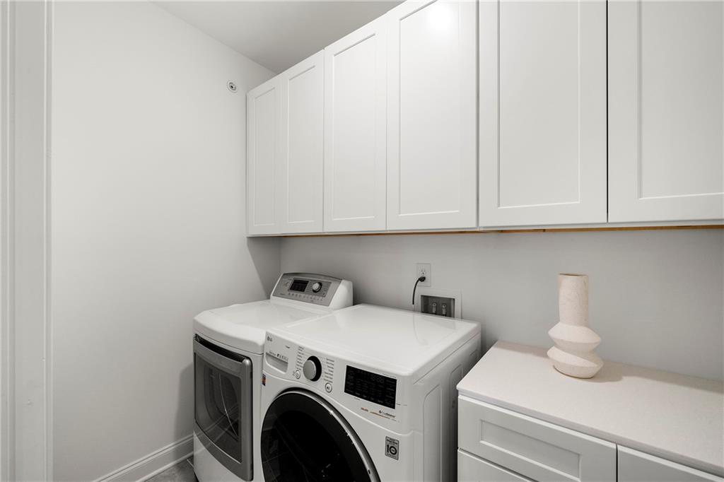 Laundry area with cabinets