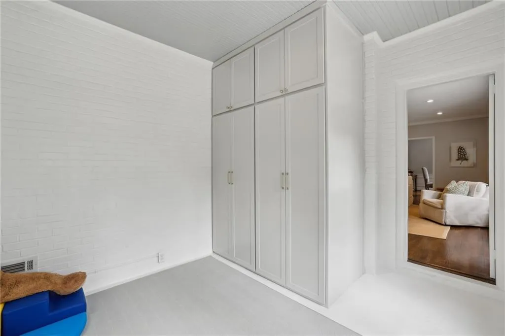 Stacked washer/dryer inside left cabinet.