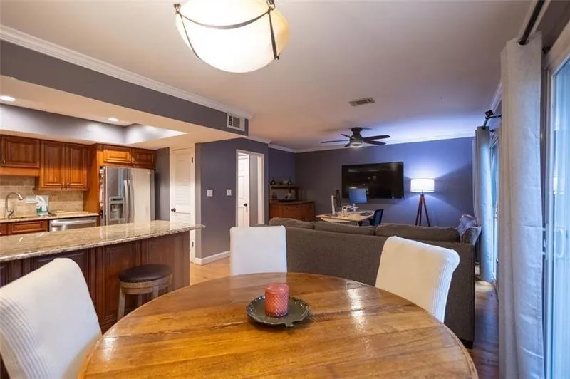 Dining room with ceiling fan, crown molding, and sink
