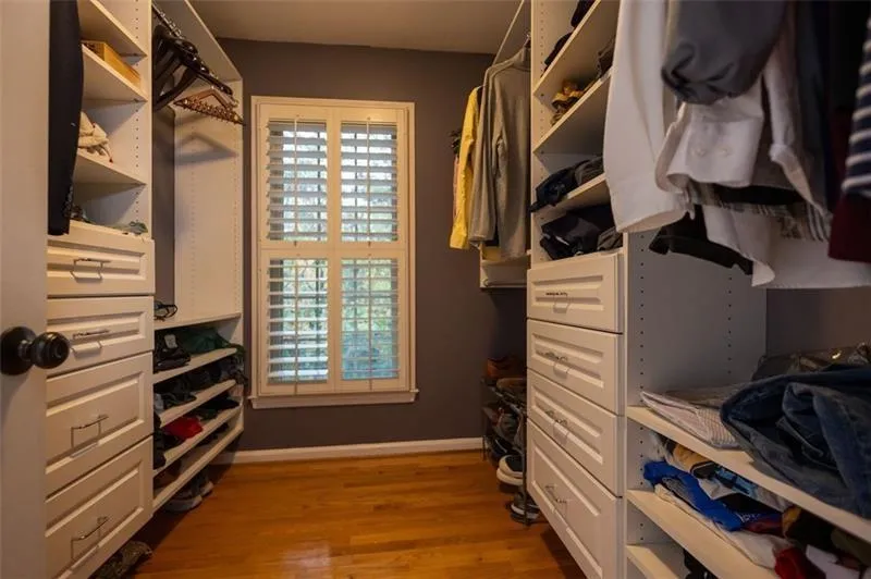 Spacious closet with hardwood / wood-style floors