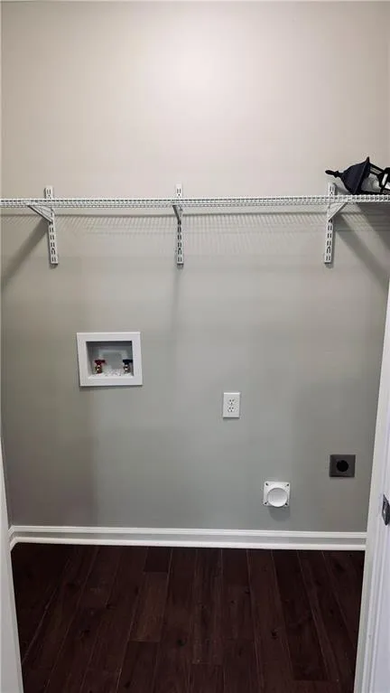 Laundry area featuring washer hookup, wood finished floors, and hookup for an electric dryer
