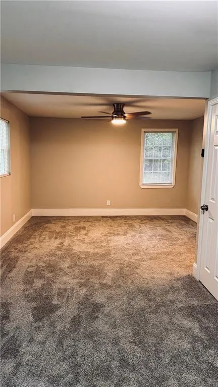Carpeted empty room with healthy amount of natural light