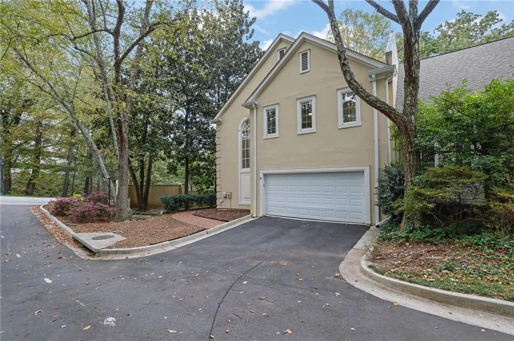 Side Entry 2 Car Garage with Additional Parking Behind and Paved Brick Walkway to Front Door
