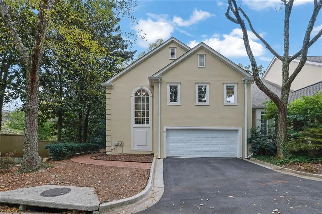 Side Entry 2 Car Garage with Additional Parking Behind and Paved Brick Walkway to Front Door