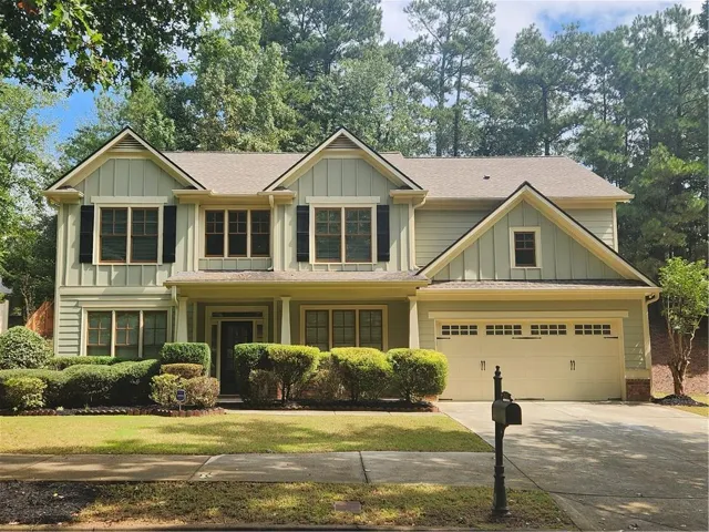 Craftsman-style exterior with board and batten siding and stone accents