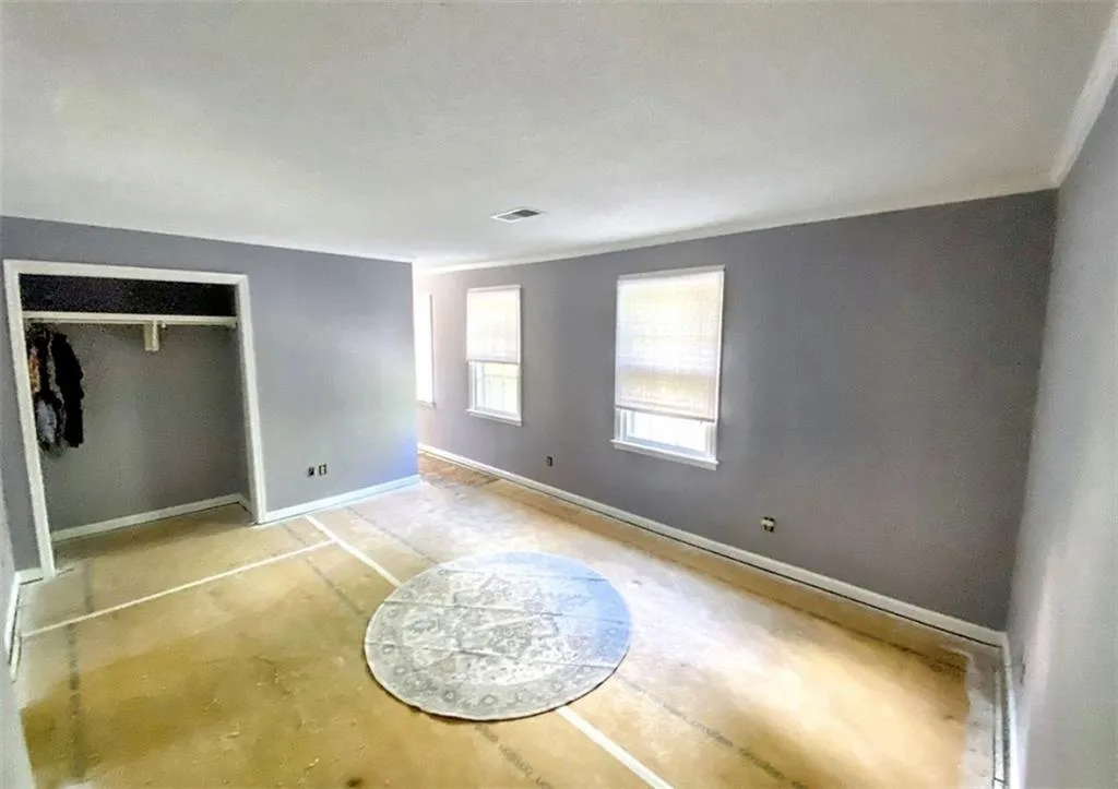 Unfurnished bedroom with a closet and baseboards