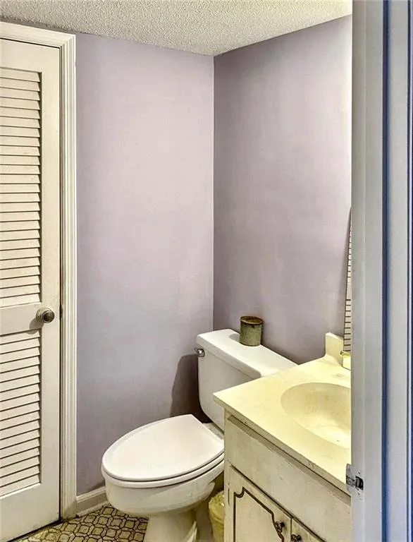 Bathroom featuring vanity and a textured ceiling