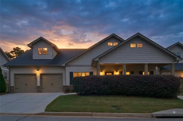 From the moment you arrive, the inviting deep front porch, custom exterior sconce lighting, and beautifully manicured lush landscapting-highlighted by privacy hedging-set a serene, welcoming tone.