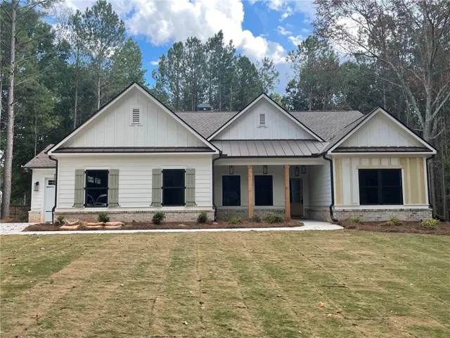 White board-and-batten siding with gray shutters