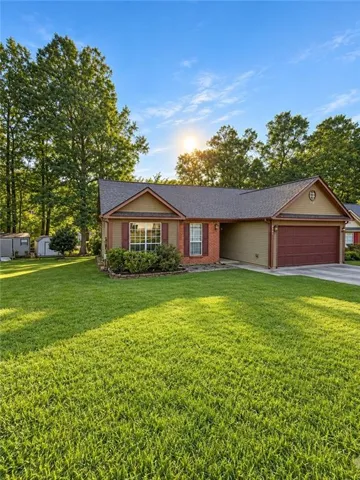 Front exterior featuring a brick facade, gabled roofline, and attached garage