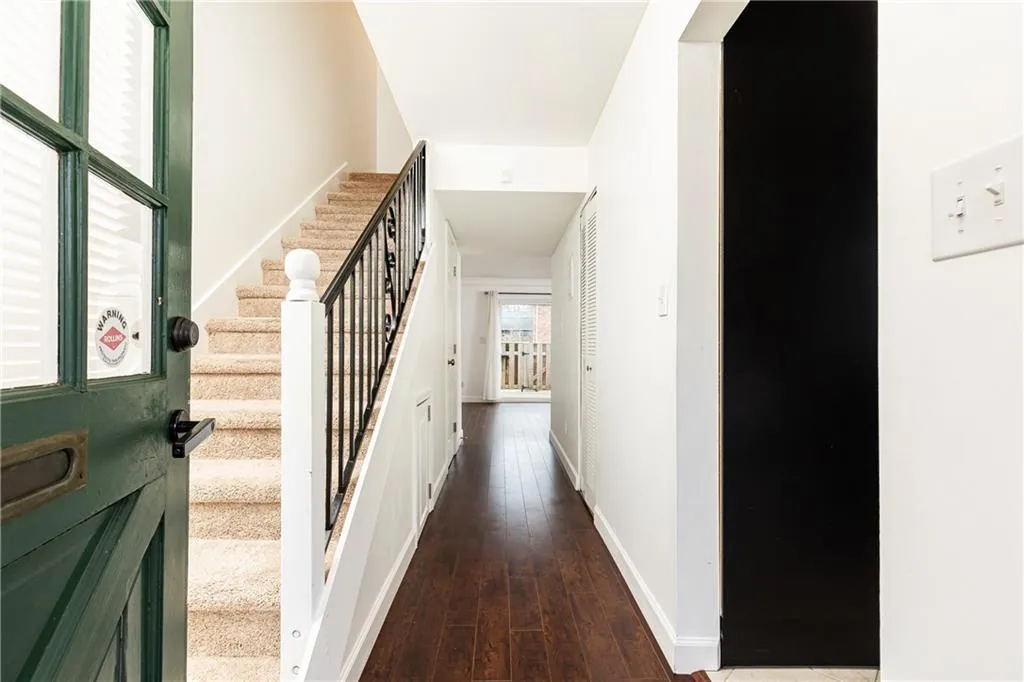 Entryway through Front door with kitchen to the right and living room straight ahead.