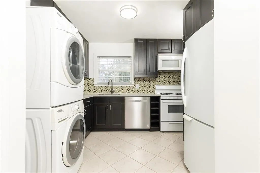 Spacious kitchen with gas range, brand new dishwasher, pantry and ample counterspace. Laundry in kitchen.