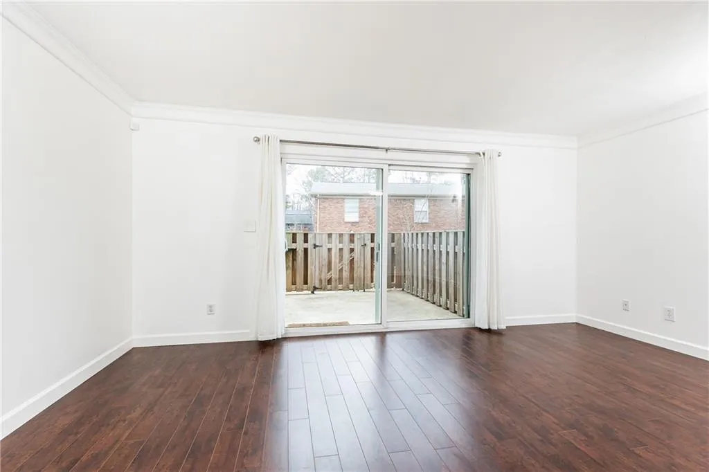 Spacious living room with sliding glass door providing abundant natural light.