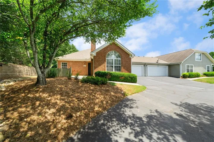 Brick and siding exterior with mature landscaping