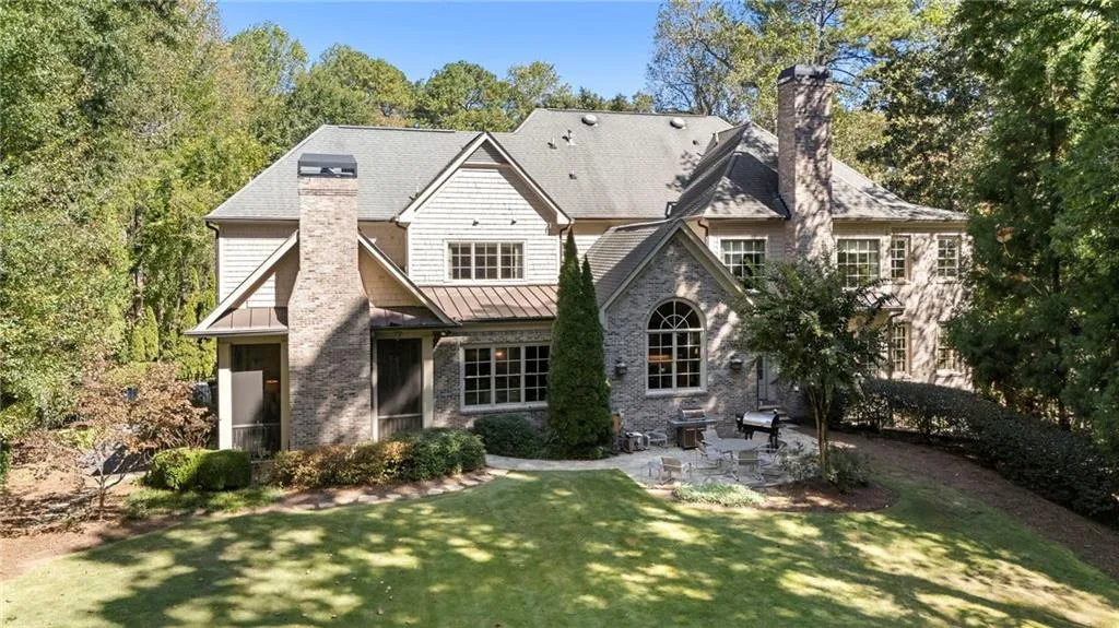 The private, flat backyard has grand entertaining space including a beautiful pool, poolhouse, firepit, and lots of additional space.
