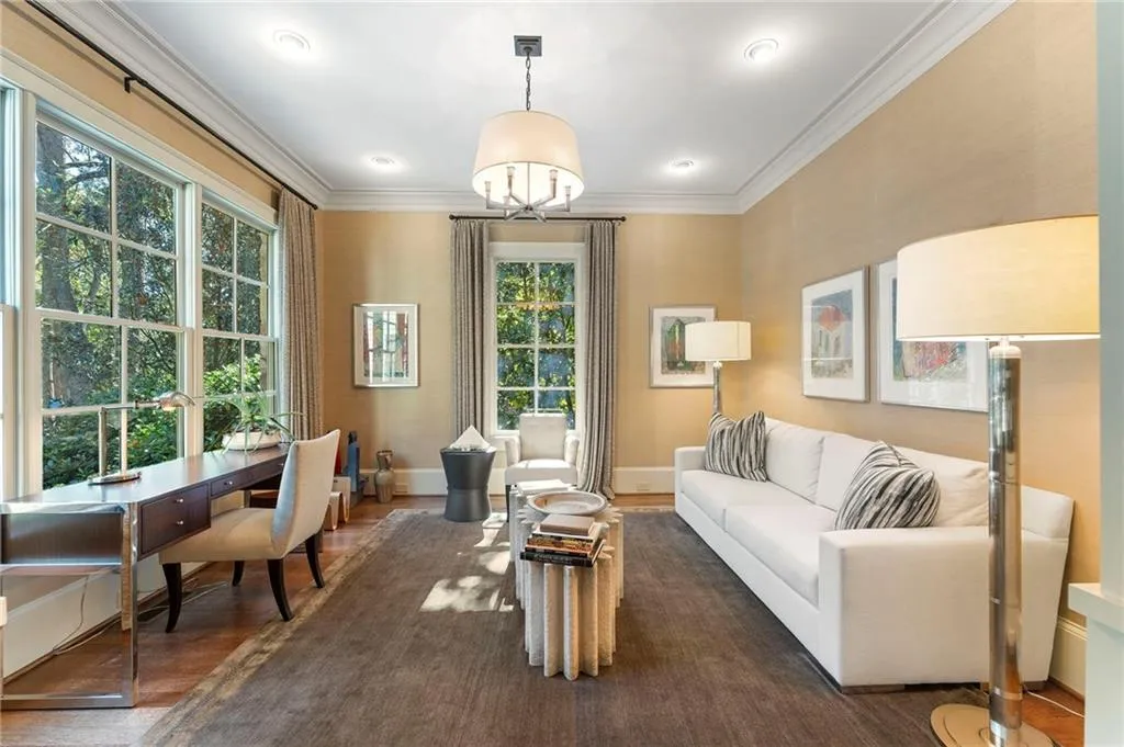 An intimate library has lots of natural light and beautiful views of the front yard.