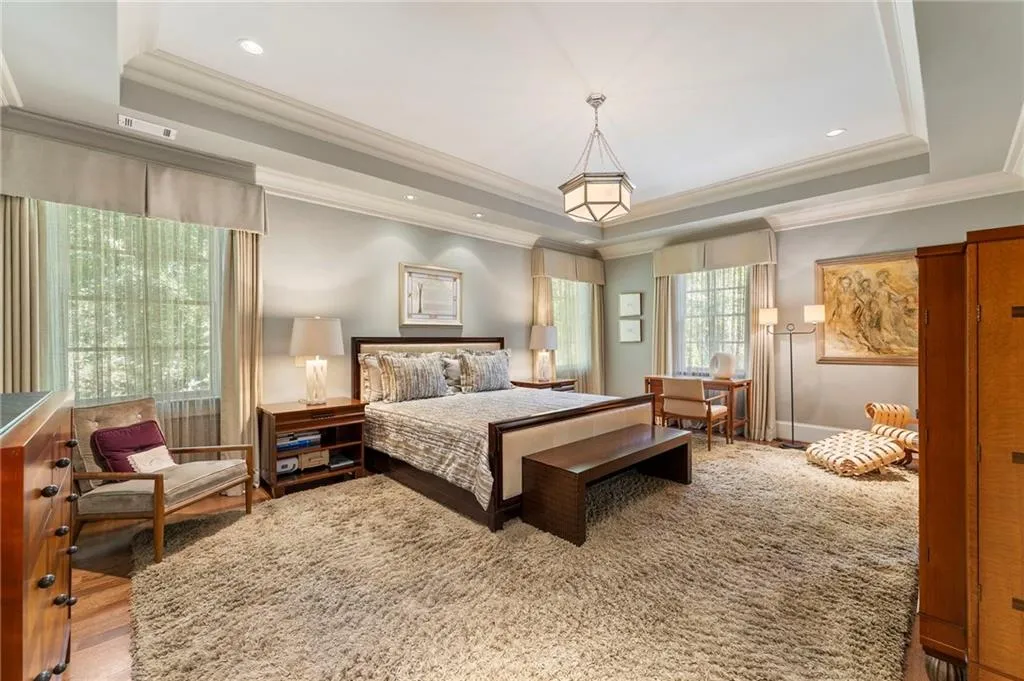 The oversized primary suite features corner windows with lots of natural light.