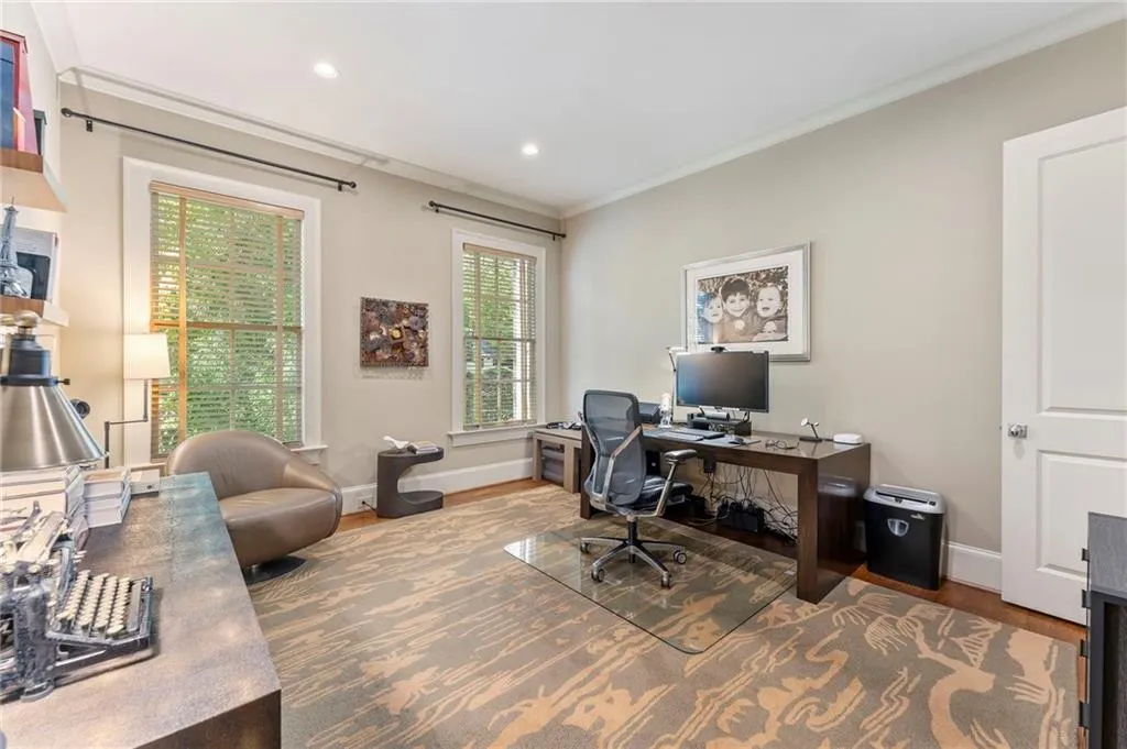 To the left of the stately living room is a full bedroom with its own private bath as well as a separate half bath for guests.